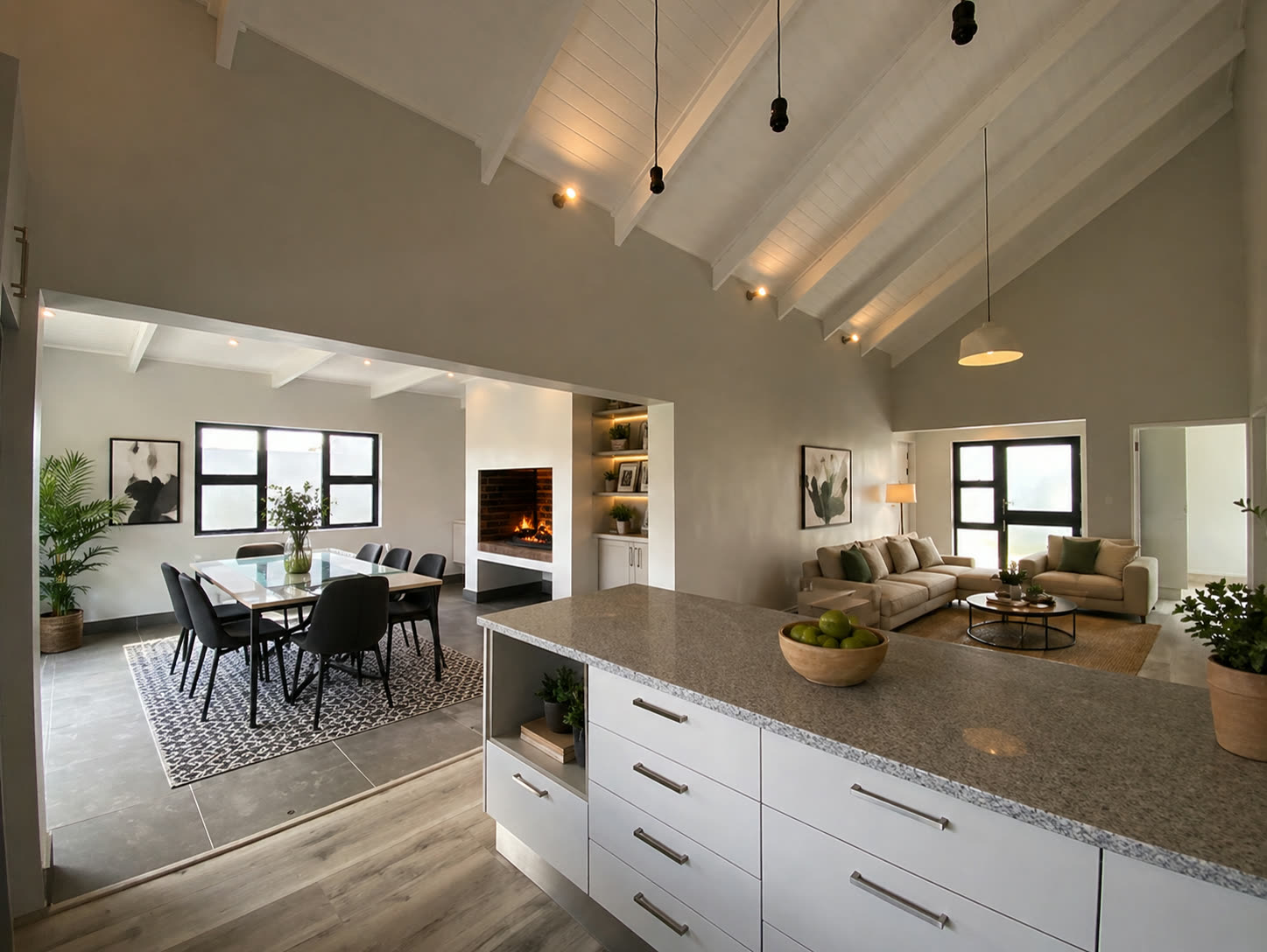 Open-plan kitchen, dining and living area with vaulted ceiling