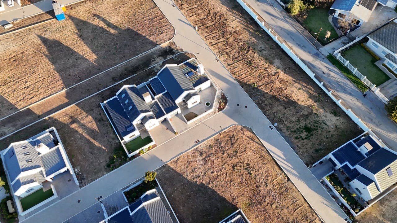 Overhead view of a completed home among open stands