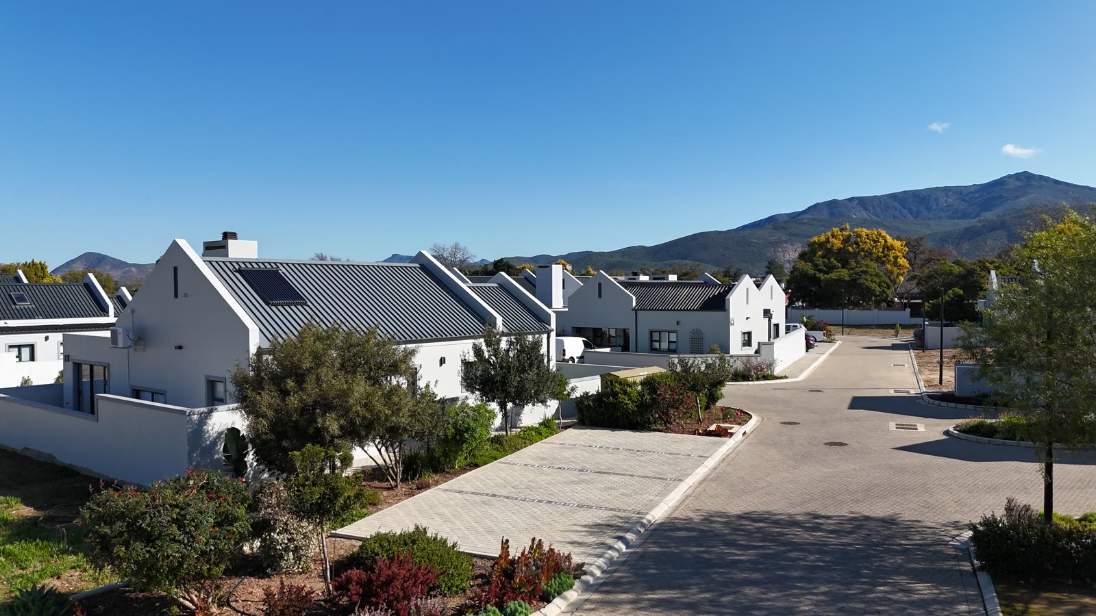 Landscaped village street with mountain views